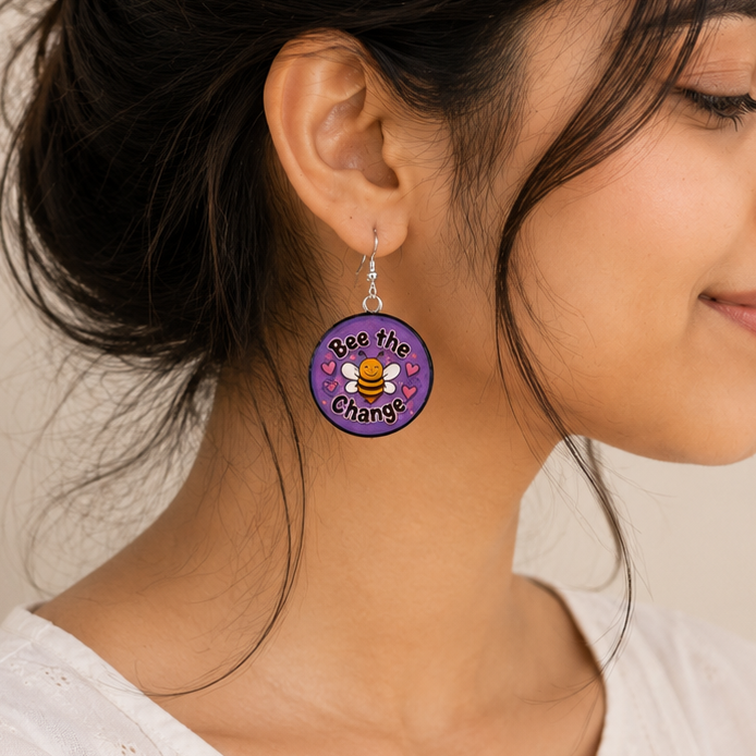 Woman wearing a unique earring with a visible brand logo.