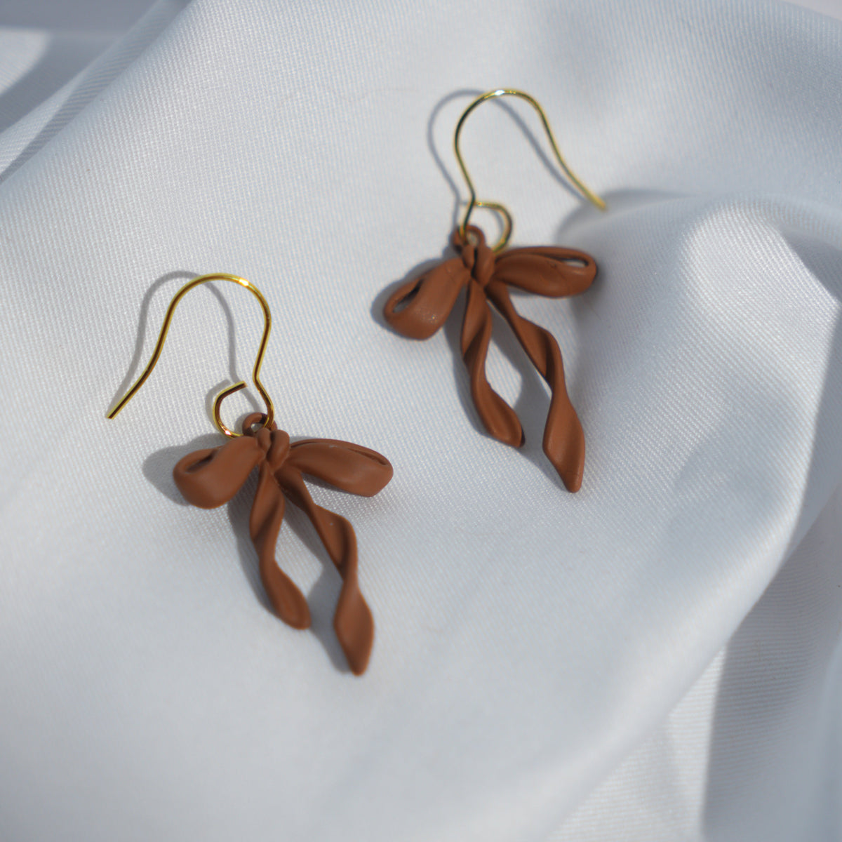 Brown Twisted Bow Enamel Earrings.