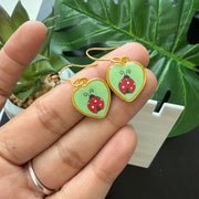 Dangling heart-shaped earring with ladybug